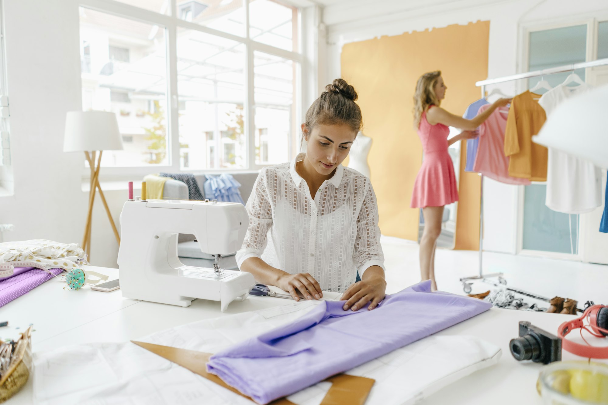 Two young women in fashion studio